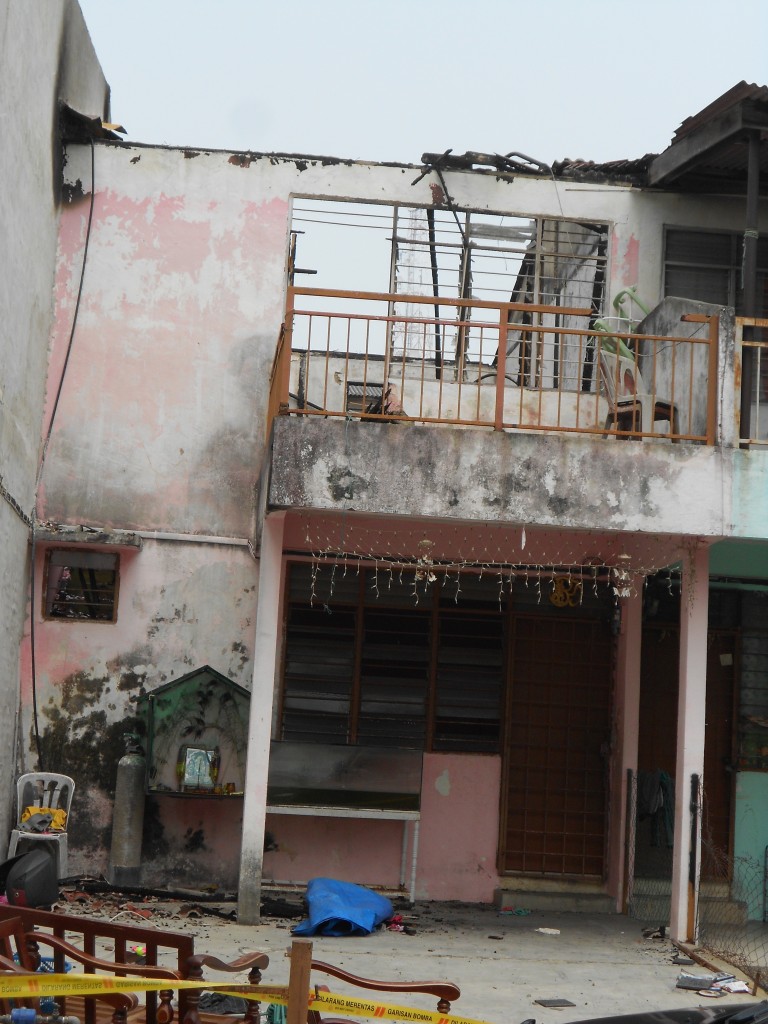 The dismal state of the exterior of one of the houses that was razed by a fire.