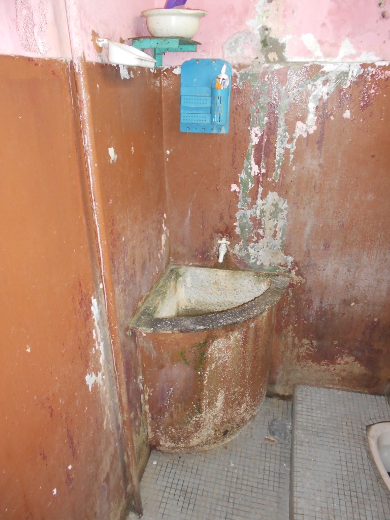 The bathroom is in dire need of repairs and a fresh coat of paint.