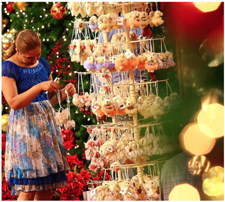 A tourist looking at the little festive gifts offered in Pavilion Kuala Lumpur.