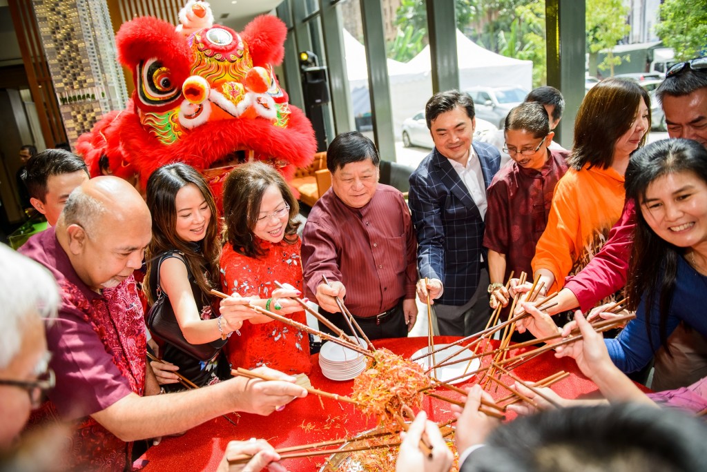 Tossing the traditional Yee Sang for a good start to the Lunar New Year.