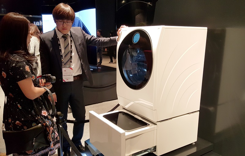 A staff member explaining how the touch-enabled quick circle user interface embedded in the glass door at 17-degree angle made it easy to see it while standing.