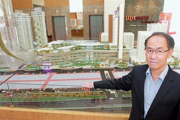 Tan showing a model of what Damansara Uptown will look like once the developments and beautification works are done.