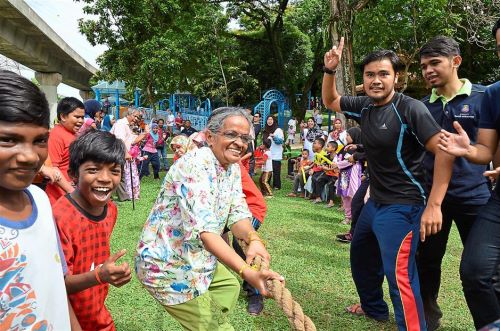 Kamalavathy (centre) shows age is no barrier to having fun, as bystanders cheered her and her fellow tug-of-war participants on during the match.