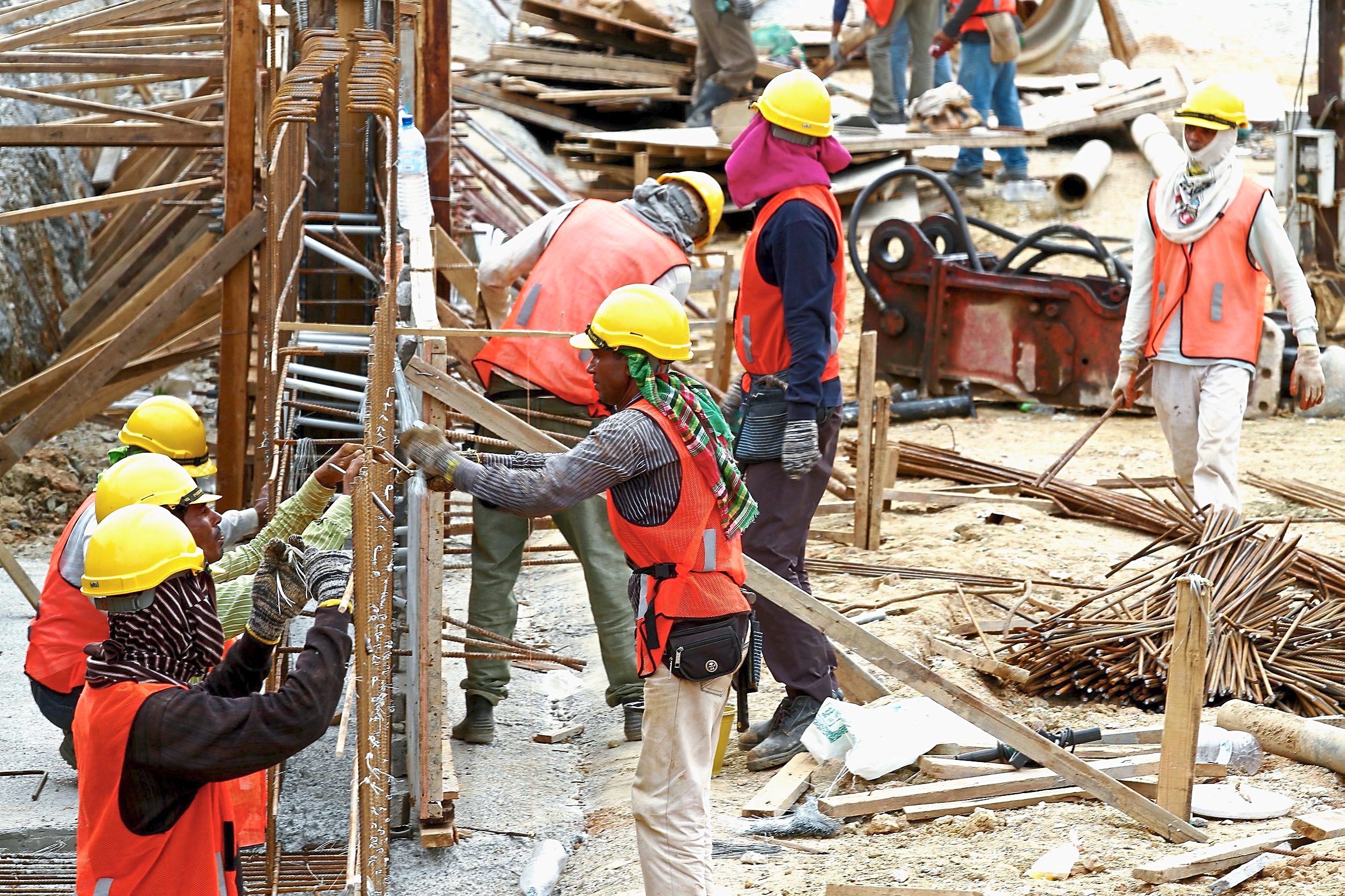 In spite of the heat, construction work on various projects is ongoing. Workers look to beat the heat with lots of liquids and protective gear.