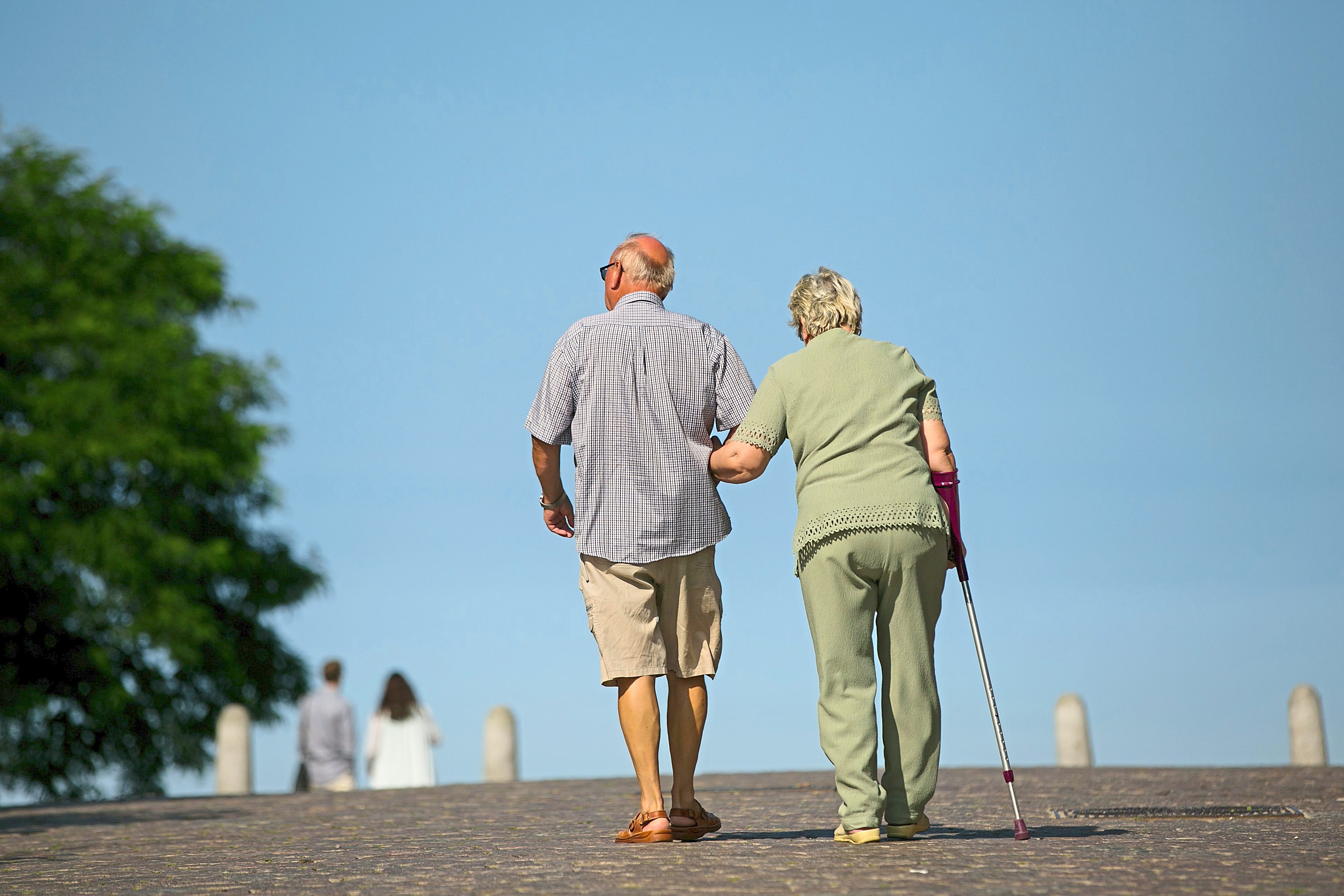 Pensioners walk on a footpath in Sellin, Ruegen Island, Germany, on Saturday, Aug. 27, 2016. Germany's Bundesbank said raising the legal retirement age to 69 by 2060 could ease some of the pressure on the country’s state pension system as the population ages. Photographer: Krisztian Bocsi/Bloomberg