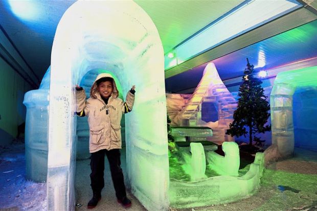 A visitor checking out an igloo at SnoWalk.