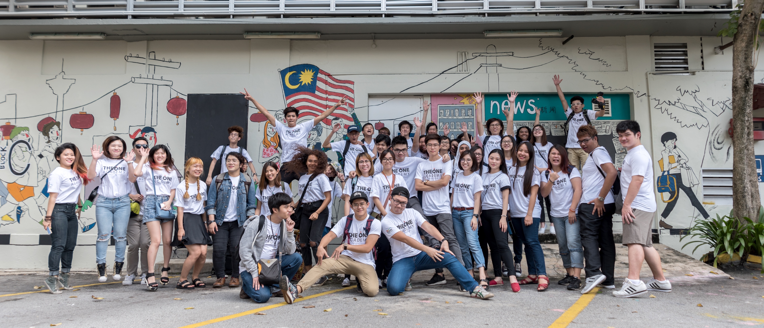 Students of The One Academy takes part in the painting project.