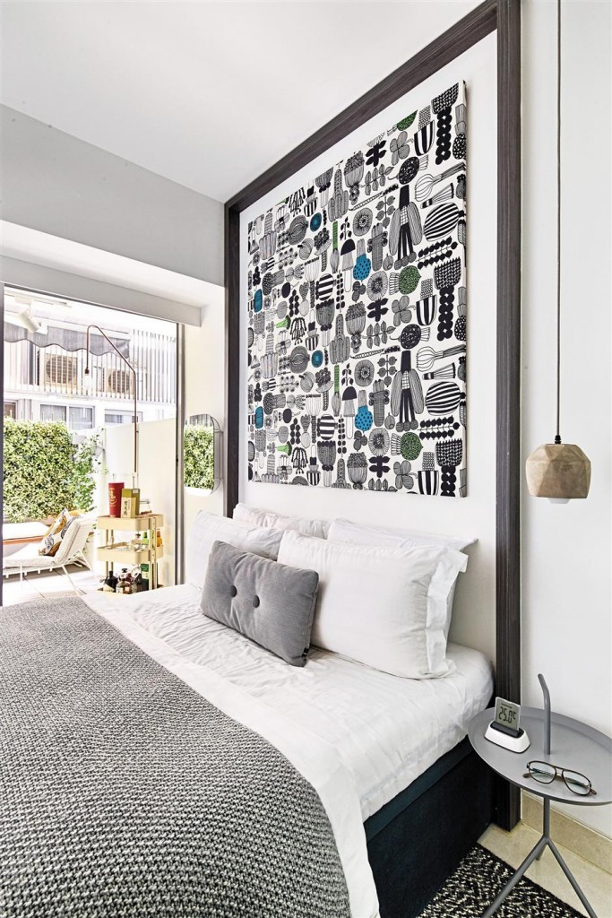 The unique headboard was created by fitting Marimekko fabric into a black frame.