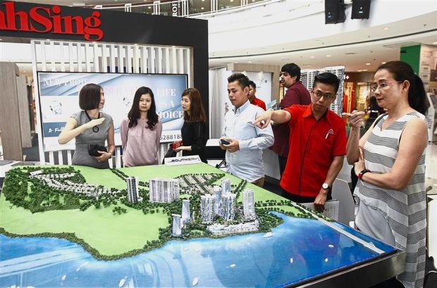 Visitors looking at the scale model of the Southbay project by Mah Sing Properties Sdn Bhd at the fair.