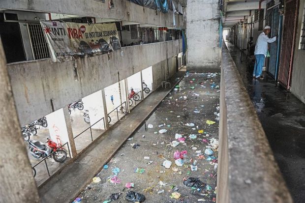 Garbage is strewn all over the Teluk Indah Flats courtyard.