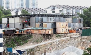 While they toil to construct buildings, labourers here are put in these kinds of ‘multi-storey‘ containers or wooden cabins perched on stilts like the ones in the foreground. — Photos: AZHAR MAHFOF, LOW LAY PHON/The Star and courtesy of Tenaganita