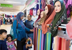 Fariza, her husband Herman and their children looking for their baju raya in KWC.
