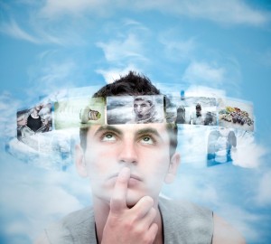 12341659 - young man analyzing photos against blue sky