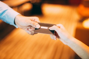 Man giving credit card to cashier for payment