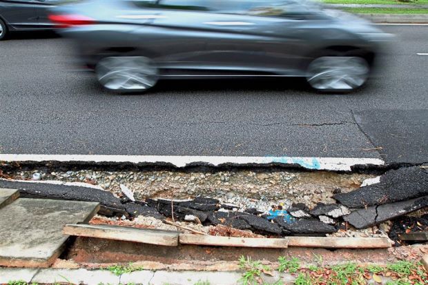 Part of the road along the stretch between the first and second roundabouts of Persiaran Anggerik Mokara has collapsed, resulting in broken drain covers