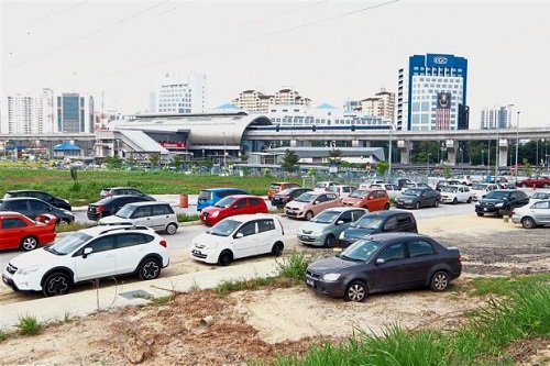 Illegally parked cars narrow the road leading into the Glenmarie LRT station.