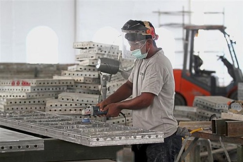 Reusable: Workers refurbishing the formworks for reuse.