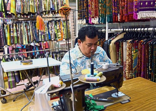 A tailor working in one of the retail outlets inside the relatively quiet Wisma Yakin.
