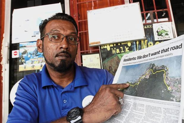 Fauzi showing Monday’s article in The Star reporting that Tanjung Bungah residents fear the route would entail deforestation. The nature guide doesn’t want trees to be cut down either but says the NCPR is needed.
