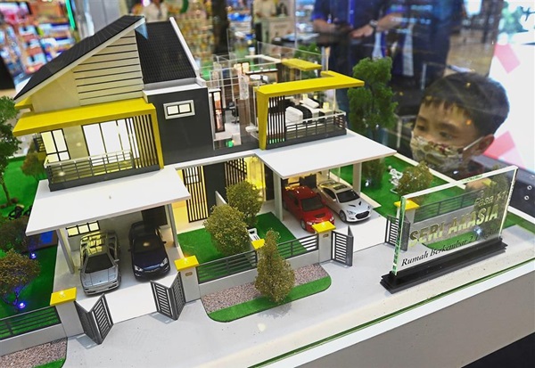 A young boy admiring the Seri Akasia scale model by JKP Sdn Bhd