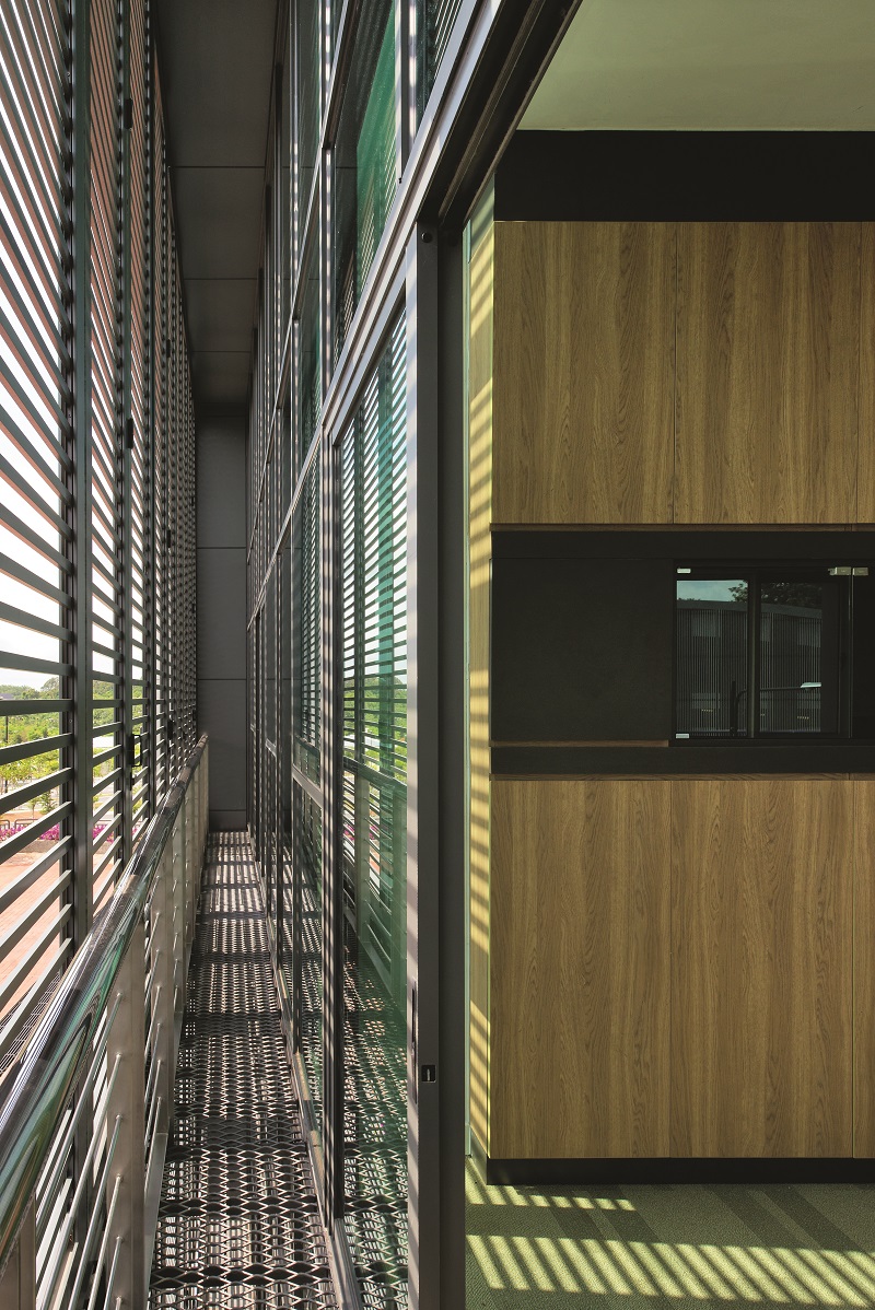 Low-emissivity glass wall and aluminium louvres help in reducing internal heat.