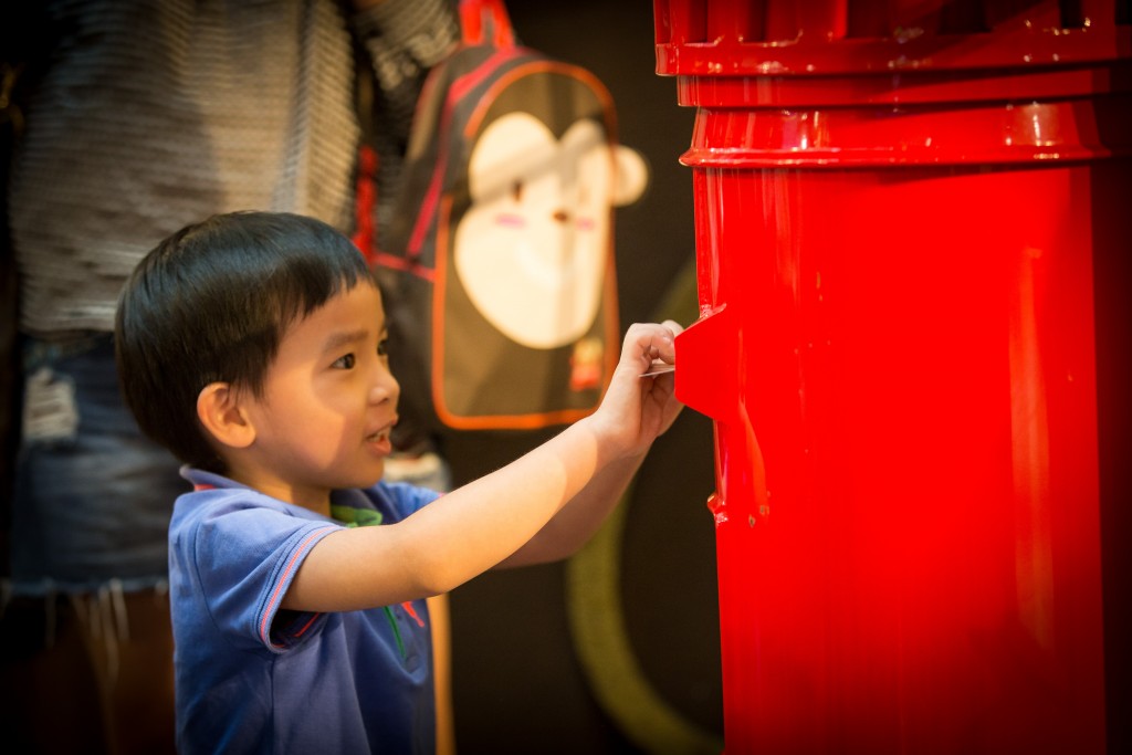 Children mailing their personalized postcards.