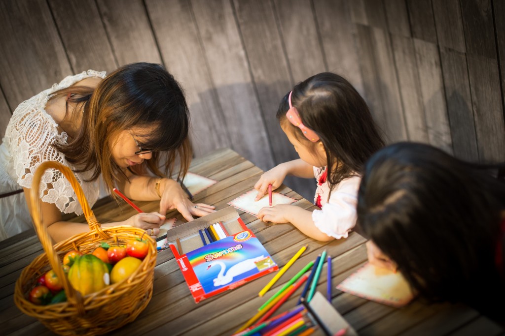 Customers personalizing their postcards before sending it off