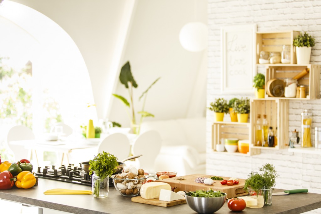 Vegetables, mushrooms and cheese on countertop, ready for preparing a healthy meal at home.