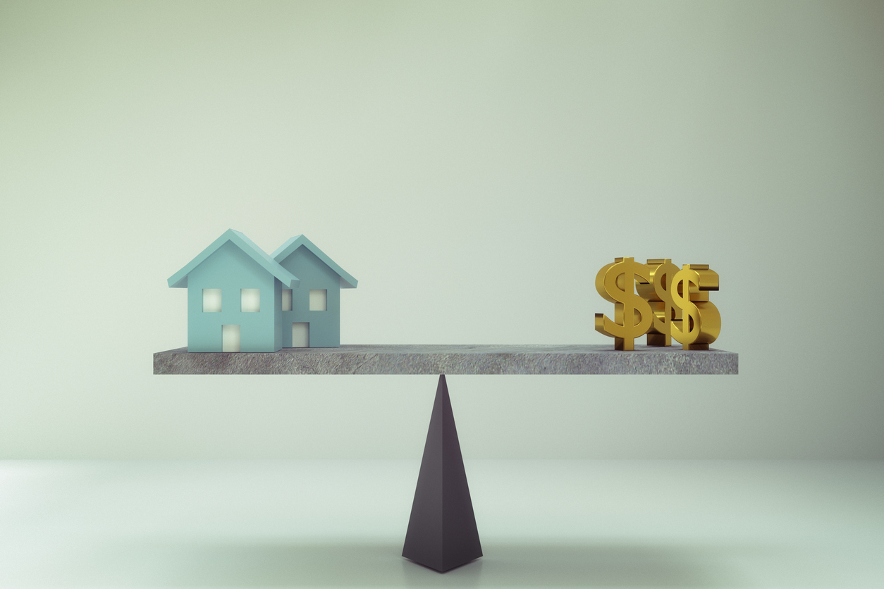 dollar sign and house on balance board