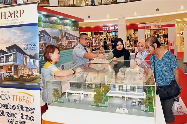Unbeatable deals: A prospective buyer looking at projects being offered during the StarProperty.my Fair 2018 at Aeon Mall Bandar Dato Onn, Johor Baru.