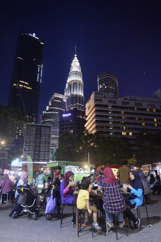 Families enjoying some urban street dining along Jalan Ampang.