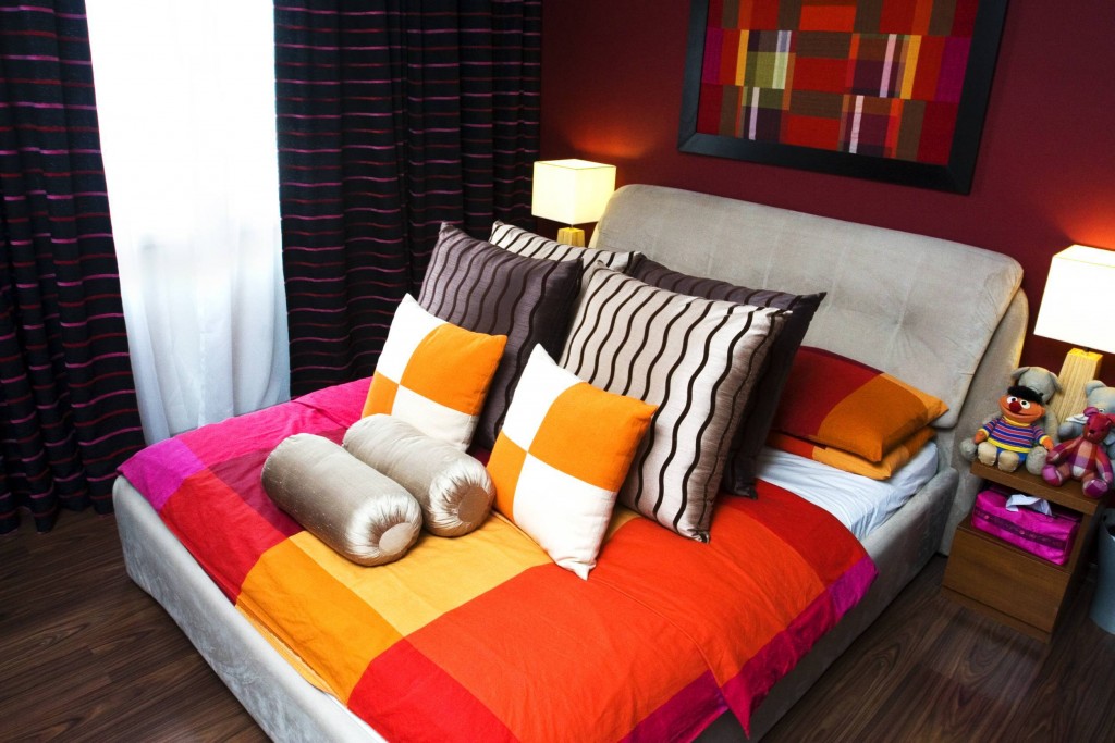 The bedroom is designed for maximum impact as the vivid colour scheme will certainly grab anyone's attention. Note the four cutesy, soft toys on the bedside table. 