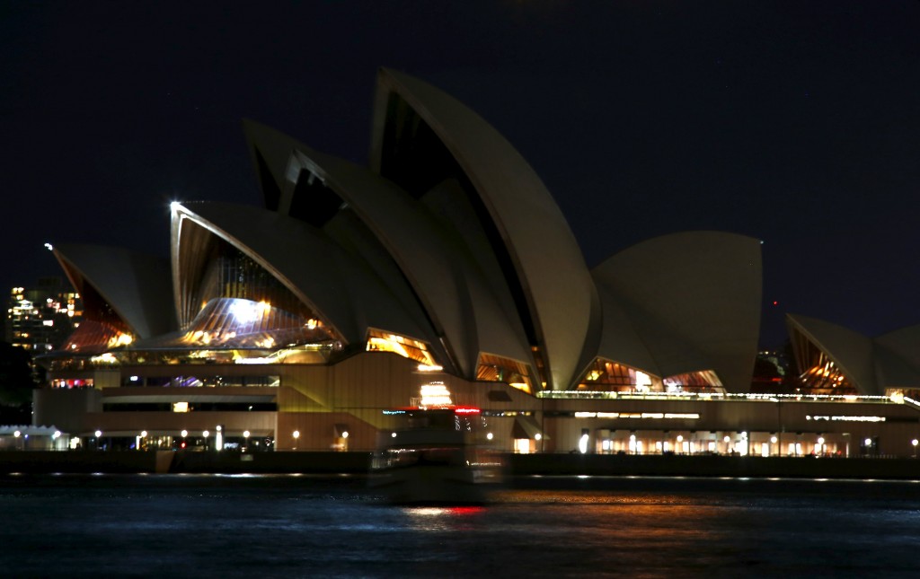 Three hours after Samoa, the lights at the Sydney Opera House are turned off. REUTERS/David Gray