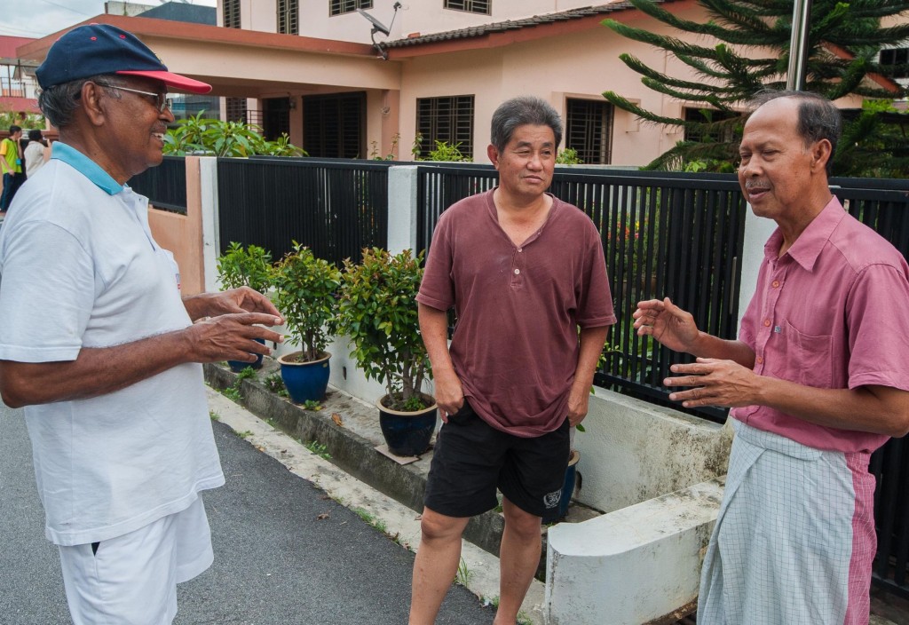 (From left) R. Narayanan, 73, Ong Cheng Tor, 59, and Azizan Din, 64, discussing the problem of clog drains affecting the neighbourhood of Lim Gardens.
