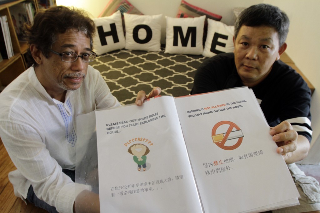 Ahmad Hamzah (left) and Ch'ng Kim Teck with a folder of rules and regulations for guests in the house built in 1934 in George Town rented out for RM600 a night by home-sharing operator S.H. Tang. Star pic by: CHAN BOON KAI/ The Star/ (29th June 2016)