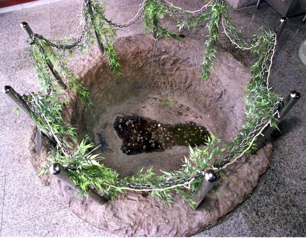 The mythical footprint of the legendary Admiral Zheng He, surrounded by a rock enclosure in the temple hall at the Sam Poh Tong Footprint Temple in Batu Maung, Penang.
