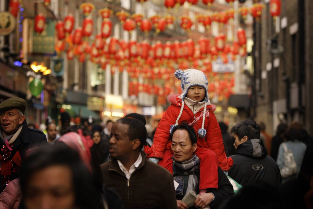 Crowds walk underneath lanterns hanging in Chinatown in London to celebrate the Lunar New Year.