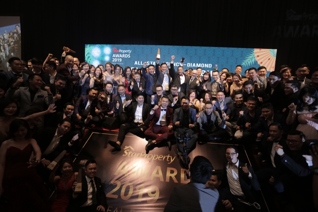 Real estate negotiators and other representatives  of IQI Realty celebrate the win of a dozen awards at the 2019 SREA.