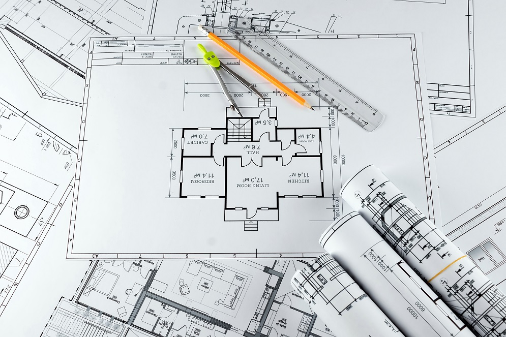 Architectural construction drawings twisted into a roll, construction projects on paper. The concept of architecture, construction, engineering. Copy space.