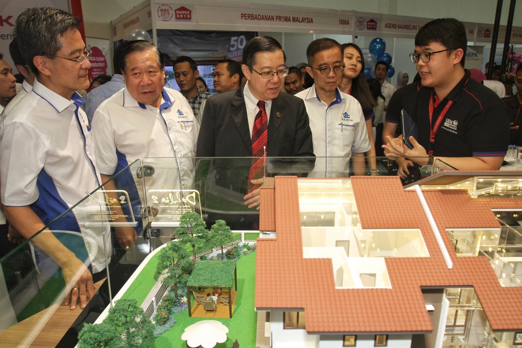 Finance Minister Lim Guan Eng (centre) taking a look at the properties offered at the Mapex event earlier in the year as (from left) Home Ownership Campaign 2019 organising chairman Datuk NK Tong, Mapex organising chairman Dartuk Ng Seng Liong and Rehda president Datuk Soam Heng Choon look on.
