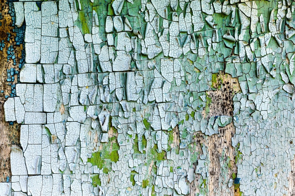 old, weathered boards with peeling paint.