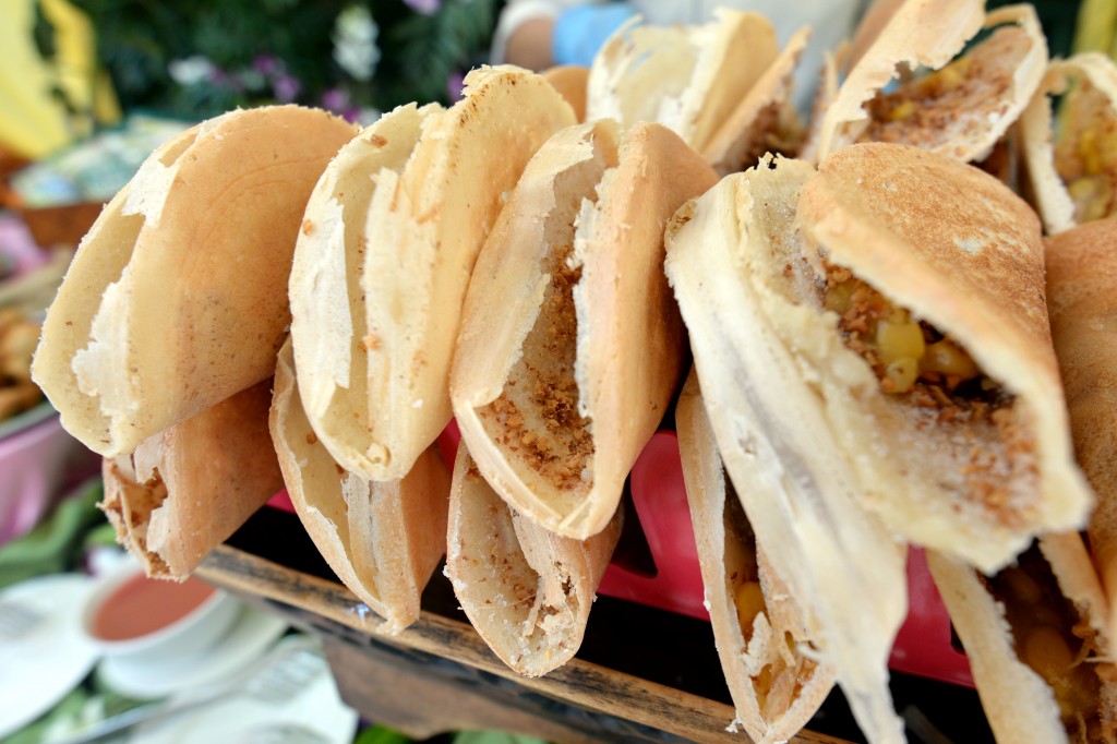Apam balik is a sweet Asian pancake typically found at roadside stalls, with either a crispy or fluffy variation.