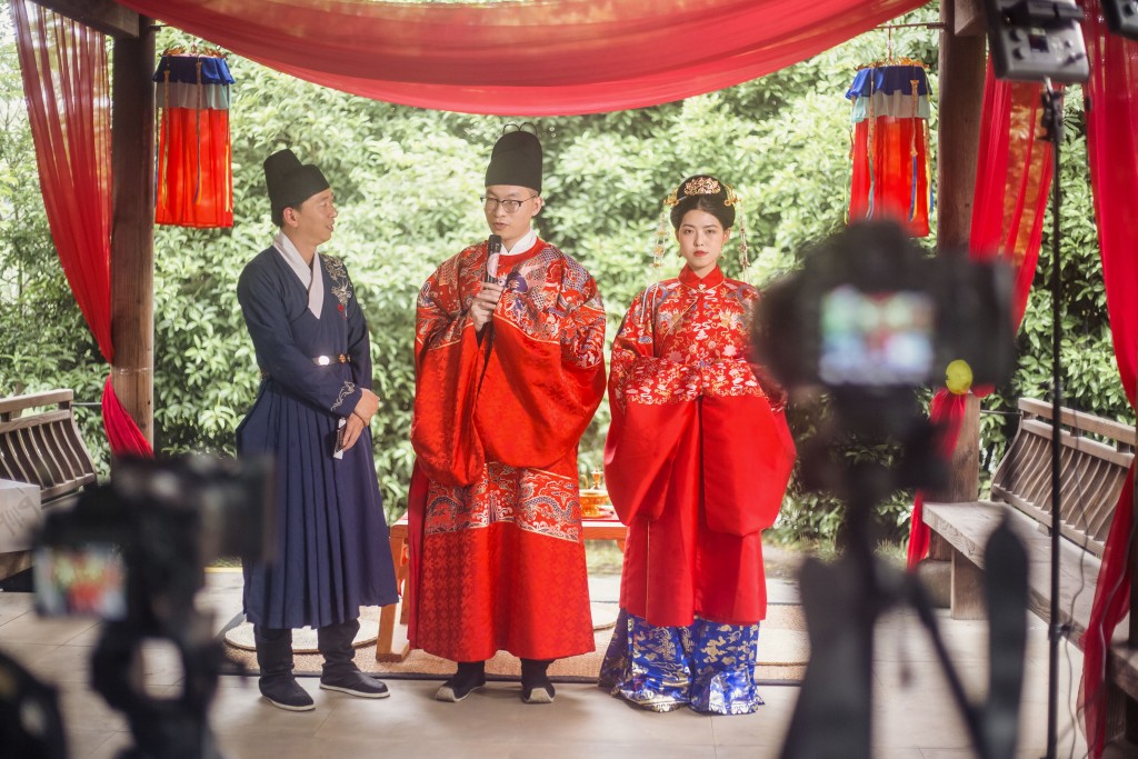 A traditional marriage ceremony in China being witnessed by guests online.