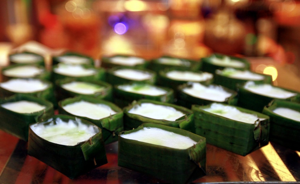 Tepung Pelita combines layers of coconut milk and pandan custard, steamed in little banana leaf or pandan containers.