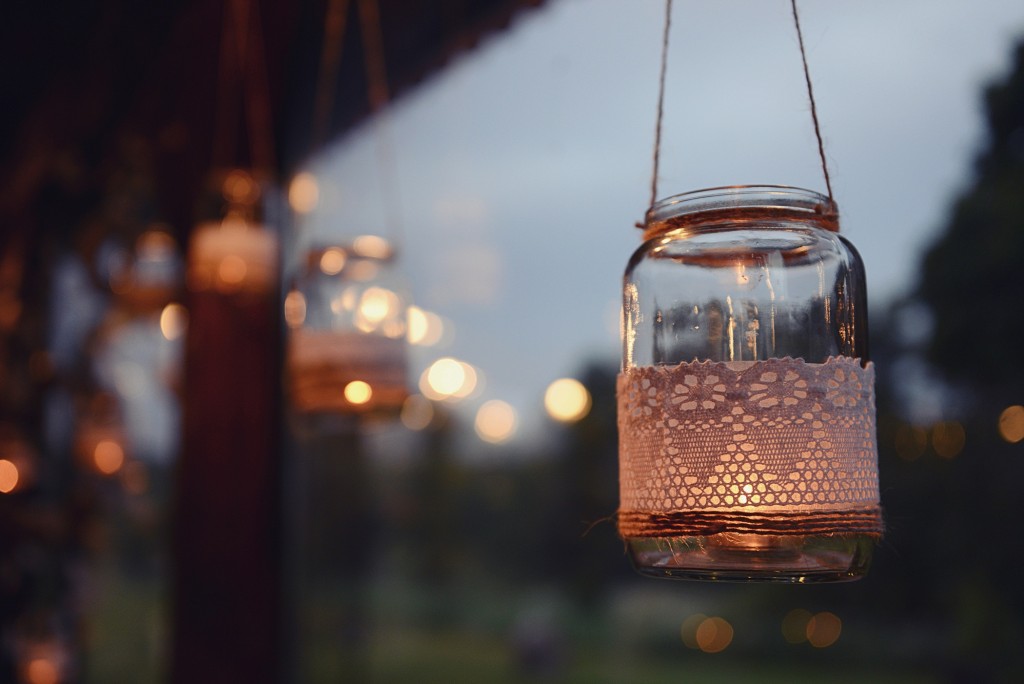 Mason jar candle hanging for wedding decor. Evening light. window