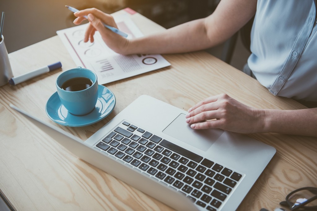 Woman arms using digital device at work