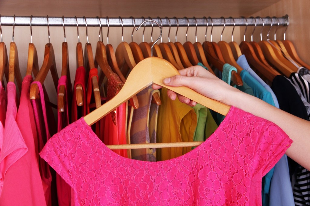 Colorful clothes hanging in wardrobe