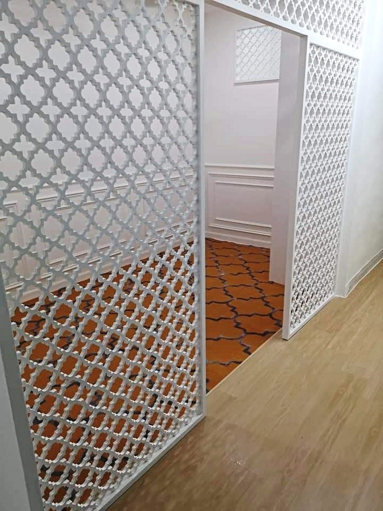 A mini-surau at home with lasercut partitions, wainscot and geometric rugs made by Cantikwall.