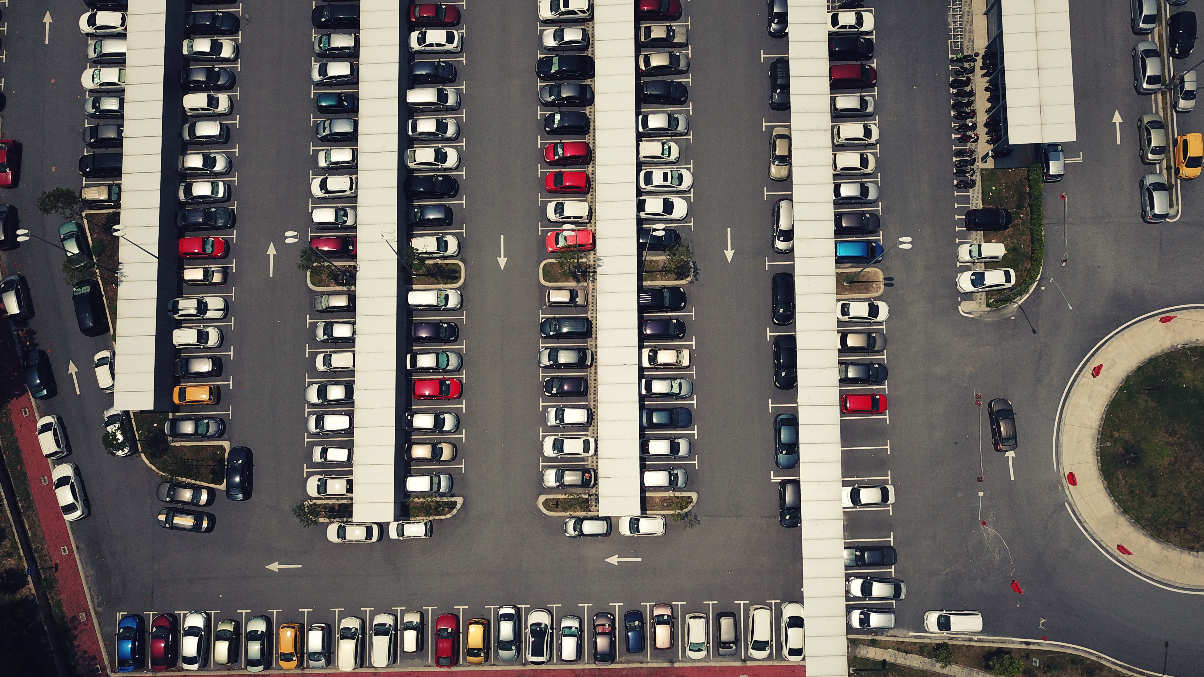 drone shot of car in parking area near MRT station