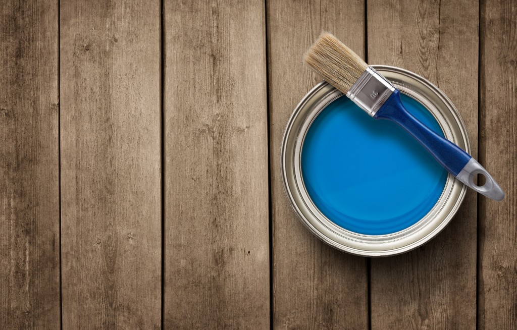 Paint can on the grunge wooden background with copy space